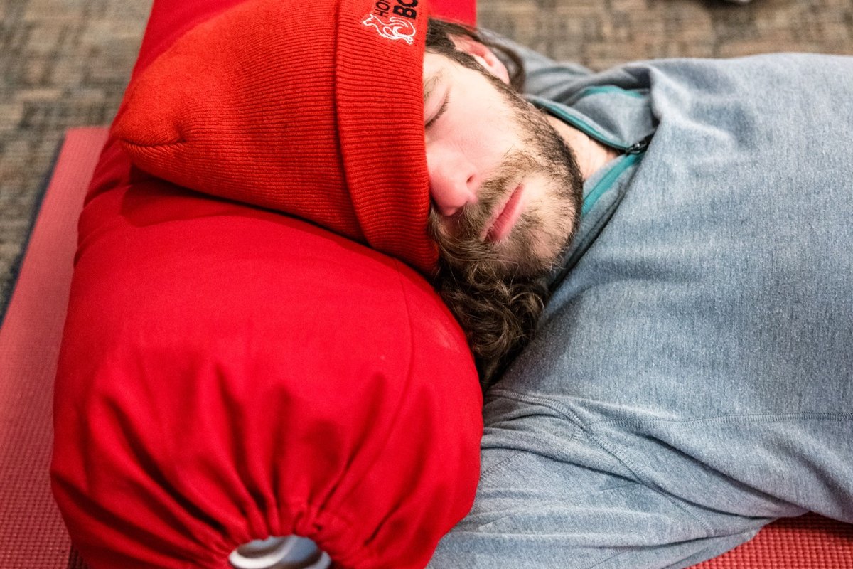 A student resting on a bolster